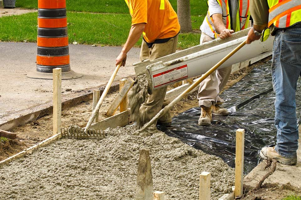 Construction crew pouring cement